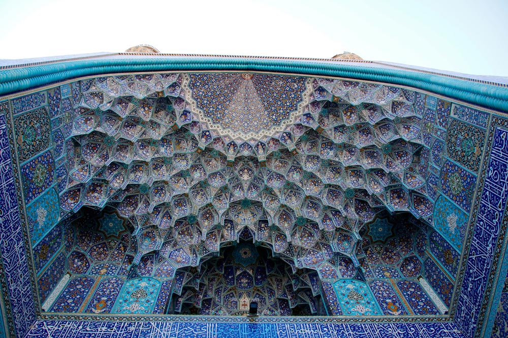 Muqarnas and tile decorations at the entrance portal of the Shah Mosque in Isfahan, Iran